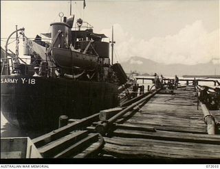 Milne Bay, New Guinea. 1944-04-05. The United States Army coastal tanker Y 18 taking on aviation fuel at the oil wharf. The shore fuel installation was manned by the 2nd Australian Bulk Petroleum ..