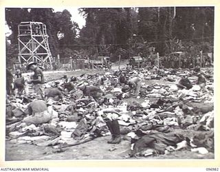 TOROKINA, BOUGAINVILLE. 1945-09-23. TROOPS OF 9TH INFANTRY BATTALION SEARCHING THE PERSONAL GEAR AND EQUIPMENT BROUGHT IN BY JAPANESE NAVAL TROOPS FROM THE BUKA AREA. THESE TROOPS HAVE JUST ARRIVED ..