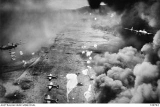 DAGUA, NEW GUINEA, 1944-02. PARACHUTE BOMBS BEING DROPPED ON THE JAPANESE AIRFIELD