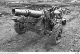 LAE, NEW GUINEA. 1944-05-03. A 25 POUNDER "SHORT" (AUSTRALIAN) MARK I GUN WHICH WAS PARACHUTED INTO THE RAMU VALLEY AND USED BY ARTILLERYMEN OF THE 2/4TH FIELD REGIMENT. THE GUN, IS THE FIRST ..