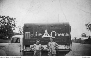 PORT MORESBY, PAPUA, 1942-1943. SERGEANT GEOFF MASTERS (LEFT) AND SERGEANT ALEX BROWN STANDING BESIDE THE TRUCK THAT SERVED AS MOBILE CINEMA NO. 75, AUSTRALIAN ARMY AMENITIES SERVICE. (DONOR: G. ..