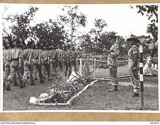 17 MILE, PORT MORESBY AREA, NEW GUINEA. 1943-12-24. VX247 BRIGADIER C. A. STINSON, DEPUTY DIRECTOR OF ORDNANCE SERVICES HEADQUARTERS, NEW GUINEA FORCE (2), TAKING THE SALUTE FROM TROOPS OF THE 10TH ..