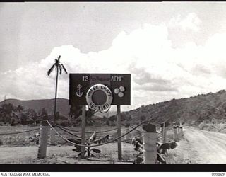 RABAUL, NEW BRITAIN, 1946-03-01. THE UNIT SIGN AT THE ENTRANCE TO THE WATERCRAFT SECTION, 12 ADVANCED WORKSHOP, CORPS OF AUSTRALIAN ELECTRICAL AND MECHANICAL ENGINEERS