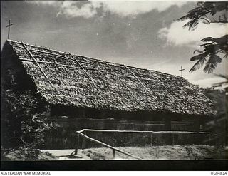 NEW GUINEA. C. 1944. THE EXTERIOR OF A RAAF CHURCH IN THE AREA SHOWING THE THATCHED ROOF