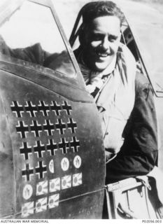 Morotai, New Guinea. 1945. Portrait of Group Captain Clive (Killer) Robertson Caldwell, DFC and bar, DSO, commanding officer of No. 80 Fighter Wing, in the cockpit of his Spitfire Mk VIIIC ..