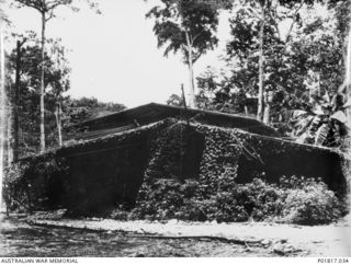 Goodenough Island, D'Entrecasteaux Islands, Papua, 1944-03-10. The Air Intelligence Hut at the Headquarters of No. 71 Wing RAAF. The hut is partly covered by camouflage netting