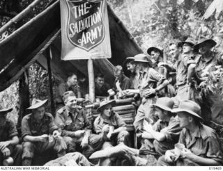 1943-08-09. NEW GUINEA. AUSTRALIAN SOLDIERS ON THEIR WAY TO THE FORWARD AREAS HEAR MUBO STOP AT A SALVATION ARMY TENT FOR A CUP OF COCOA AND BISCUITS. THE TENT IS A COMPARATIVELY SHORT DISTANCE ..