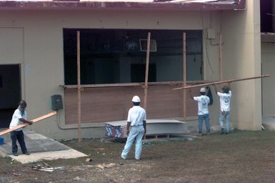 Contractors hired by the Federal Emergency Management Agency enclose what will be a dinning facility. It is part of temporary housing for typhoon victims at Andersen South Air Force Base, Guam, after Super Typhoon Paka