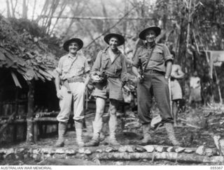 GOODVIEW, NEW GUINEA, 1943-08-03. V504081 WARRANT OFFICER 2 E. BRITTEN, AUSTRALIAN AND NEW GUINEA ADMINISTRATIVE UNIT (LEFT), DAMIEN PARER, WAR PHOTOGRAPHER (CENTRE) AND NG2022 SERGEANT A. M. ..