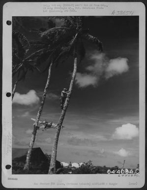 Sgt. Marvin S. Hollinger, A Linesman Who Is Stringing A Communications Wire, Stops His Work To Watch A Consolidated B-24 Liberator Of The 11Th Bomb Group, Take Off From Guam, Marianas Island, January 1945. (U.S. Air Force Number 64408AC)