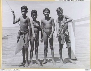 PORT MORESBY - YOUNG PAPUAN NATIVE BOYS - LEFT TO RIGHT - HAIRAI MONISE, IGO KAROHO, FRANK AISI, AND VI KORO OVA. RAAF SURVEY FLIGHT. (NEGATIVE BY N. TRACY)