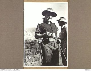 KUMBARUM, NEW GUINEA. 1943-11-14. MAJOR GENERAL J. S. LETHBRIDGE CBE MC (1), LEADER OF THE BRITISH MILITARY MISSION TO AUSTRALIA, AND NX3 BRIGADIER K. W. EATHER, CBE DSO ED (2), ENJOYING A CUP OF ..