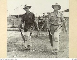 SOUTH ALEXISHAFEN, NEW GUINEA. 1944-09-10. QX44212 PRIVATE C.T. O'CONNOR (1) AND NX95472 LIEUTENANT F.S. WOOD (2) OPENING BATSMEN FOR HEADQUARTERS, 5TH DIVISION WALKING OUT TO THE WICKET FOR THE ..