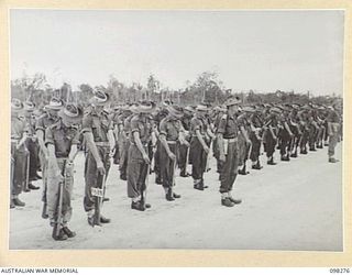 WEWAK, NEW GUINEA. 1945-10-26. A CEREMONIAL PARADE AND MARCH PAST BY 6 DIVISION WAS INSPECTED BY GENERAL SIR THOMAS A. BLAMEY, COMMANDER-IN-CHIEF, ALLIED LAND FORCES, SOUTH WEST PACIFIC AREA, AT ..