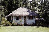 French Polynesia, thatched-roofed cottage on Tahiti Island