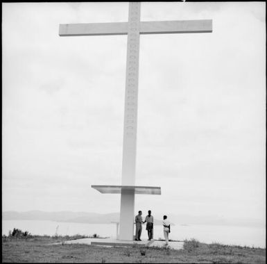 Three men standing at the base of a giant cross, Taveuni, Fiji, 1966 / Michael Terry