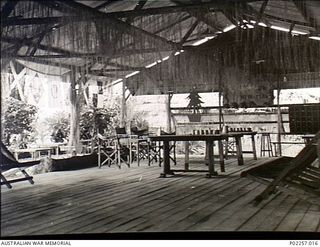 Madang, New Guinea, 1945-12-25. Interior of the Officers' Mess at Headquarters, RAAF Northern Command (NORCOM), decorated for Christmas. Streamers improvised from some sort of local grass hang down ..