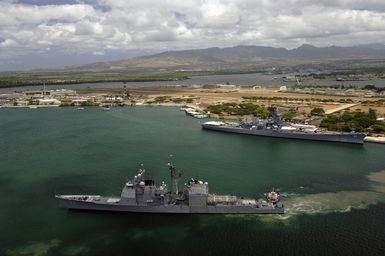 The US Navy (USN) Ticonderoga Class Guided Missile Cruiser USS MOBILE BAY (CG 53) (foreground) departs Naval Station (NS) Pearl Harbor, Hawaii (HI), to participate in Exercise Rim of the Pacific (RIMPAC) 2006. RIMPAC is an exercise designed to increase the tactical proficiency of participating units in a wide array of combined sea operations. RIMPAC 2006 brings together military forces from Australia (AUS), Canada (CAN), Chile (CHL), Peru (PER), Japan (JPN), the Republic of Korea (KOR), United Kingdom (UK) and the United States (US). In the background is the USN Arleigh Burke Class (Flight I) Guided Missile Destroyer (Aegis) USS STETHEM (DDG 63)