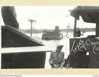 HANSA BAY, NEW GUINEA. 1944-06-26. A SUNKEN JAPANESE VESSEL IN CLOSE TO THE SHORE AS SEEN FROM AN AMERICAN LCM (LANDING CRAFT, MECHANISED) (FOREGROUND)