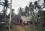 Federated States of Micronesia, man outside stilt home on Pohnpei Island