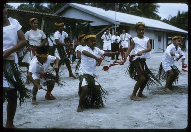Group of unidentified children dancing at a ceremony during Sir Arthur Porritt's state visit to Palmerston Island