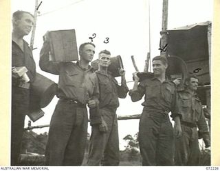 KILIGIA, NEW GUINEA. 1944-04-10. AN HOUR AND A HALF BEFORE THE SCREENING OF THE FILM "CHARLEY'S AUNT", AT HEADQUARTERS 5TH DIVISION AREA TROOPS ARRIVE WITH AN ASSORTMENT OF SEATS