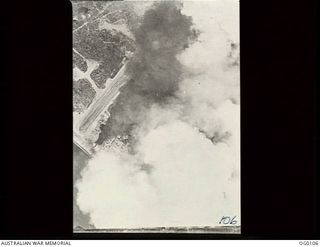 NABIRE, DUTCH NEW GUINEA. 1943-06-09. THE JAPANESE HELD AIRFIELD ON THE SOUTH COAST OF DUTCH NEW GUINEA UNDER A PALL OF SMOKE AFTER AN AIR ATTACK BY ALLIED AIRCRAFT BASED IN THE NORTHERN TERRITORY