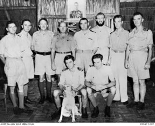 LUNGGA, GUADALCANAL, SOLOMON ISLANDS, 1944-01-15. GROUP PORTRAIT OF THE DEPUTY SUPERVISING INTELLIGENCE OFFICER (DSIO), NAVAL INTELLIGENCE DIVISION, RAN, AND FELLOW OFFICERS IN THE WARDROOM AT HIS ..