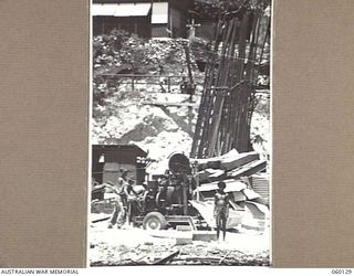 NAPA NAPA, NEW GUINEA. 1943-11-12. SAPPERS OF THE 18TH AUSTRALIAN FIELD COMPANY, ROYAL AUSTRALIAN ENGINEERS, MIXING CONCRETE FOR A NEW SLIPWAY AT THE 2ND AUSTRALIAN WATERCRAFT WORKSHOPS, AUSTRALIAN ..