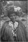 New mother wearing long fiber shawl, flower garland, skirt valuable on head, and paint on face