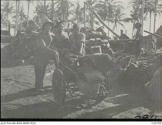 LOS NEGROS ISLAND, ADMIRALTY ISLANDS. 1944-03-18. AN ABANDONED JAPANESE HAND-CART MAKES LIGHT WORK OF TRANSPORT OF SUPPLIES FOR RAAF MEMBERS, LEADING AIRCRAFTMAN L. C. LOTT, COBURG, VIC (LEFT), ..