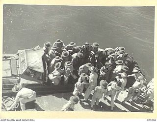 LAE, NEW GUINEA. 1944-08-14. NURSING SISTERS FROM THE 2/11TH GENERAL HOSPITAL DISEMBARKING FROM AN AMPHIBIOUS "DUKW" ONTO A BARGE FOR EMBARKATION ABOARD THE 2/1ST HOSPITAL SHIP, "MANUNDA" FOR THEIR ..