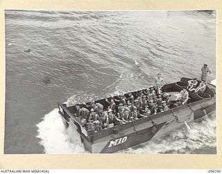 JACQUINOT BAY, NEW BRITAIN. 1945-09-09. A BARGE LOAD OF TROOPS OF 4 INFANTRY BRIGADE FOR EMBARKATION ON HMAS MANOORA. THE MANOORA CARRIED TROOPS FOR THE OCCUPATION OF THE RABAUL AREA, FOLLOWING THE ..
