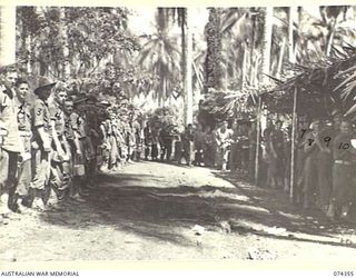 SIAR, NEW GUINEA. 1944-06-25. MEMBERS OF HEADQUARTERS COMPANY, 57/60TH INFANTRY BATTALION LINING UP AT THE KITCHEN DURING A UNIT MESS PARADE. IDENTIFIED PERSONNEL ARE:- VX142145 CORPORAL J. ..