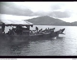 RABAUL, NEW BRITAIN, 1946-02-19. JAPANESE SOLDIERS DUMPING AMMUNITION IN THE SEA NEAR WOTAM ISLAND. DUMPING OPERATIONS OF JAPANESE AMMUNITION AND EXPLOSIVES WERE CARRIED OUT BY JAPANESE UNDER THE ..