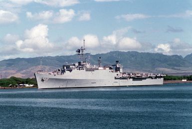 A port bow view of the amphibious transport dock USS VANCOUVER (LPD 2) departing Pearl Harbor through the channel.