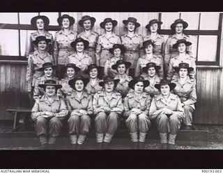 TOROKINA, 1945-08-15. GROUP PORTRAIT OF NO. 1 PLATOON, 4 AUSTRALIAN BASE SUB-AREA. TAKEN ON VICTORY IN THE PACIFIC DAY (VP DAY). BACK ROW: SERGEANT VANCE, SGT MITCHELL, SIGNALWOMAN CAMERON, SIG ..
