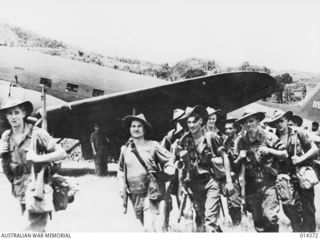 PAPUA, 1943-03-03. ALLIED PLANES HAVE FLOWN IN TROOPS FOR THE ADVANCE ON WAU. THESE AUSTRALIANS ARE FROM 2/5TH INFANTRY BATTALION. SECOND FROM THE LEFT IS PRIVATE GAVIN CULHANE. (PHOTOGRAPHER: ..