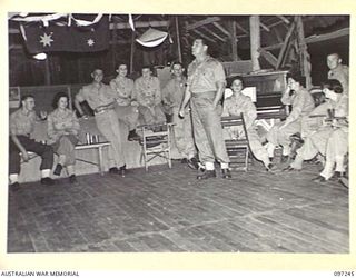 LAE, NEW GUINEA. 1945-09-05. PRIVATE J.W. COSGROVE GIVING IMPERSONATIONS DURING A VICTORY SOCIAL ARRANGED BY THE STAFF OF THE ARMY NEWSPAPER GUINEA GOLD AND ATTENDED BY AUSTRALIAN WOMEN'S ARMY ..