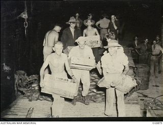 KIRIWINA, TROBRIAND ISLANDS, PAPUA. 1943-11-27. AIRMEN LOADING CASES OF AMMUNITION ONTO A TRUCK FROM THE SHIP AT NIGHT FOLLOWING THE MOVE OF NOS. 22 AND 30 SQUADRONS RAAF FROM GOODENOUGH TO ..