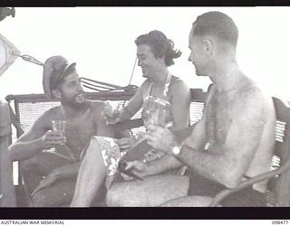 EN ROUTE TO KOIL ISLAND, NEW GUINEA, 1945-10-31. A VISIT TO KOIL ISLAND WAS ARRANGED BY THE RED CROSS FOR THE PURPOSE OF MEDICAL INSPECTION OF THE NATIVE INHABITANTS. THE VISITING PARTY CONSISTED ..