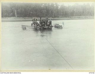 BORAI RIVER, NEW GUINEA. 1944-08-02. TROOPS OF THE 30TH INFANTRY BATTALION, ON PATROL IN THE AREA, CROSSING THE SWIFTLY FLOWING RIVER BY MEANS OF A RAFT MADE WITH EMPTY JAPANESE OIL DRUMS. ..