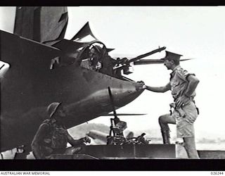 NEW GUINEA, 1942-08-11. THE CREW OF A 39TH INFANTRY BATTALION, AUSTRALIAN MILITARY FORCES, BREN GUN CARRIER PAY A CALL ON THE REAR-GUNNER OF AN AMERICAN B26 GIANT BOMBER AS IT STANDS BY ON A NEW ..