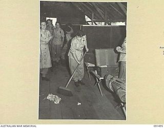 LAE, NEW GUINEA, 1945-05-07. AUSTRALIAN WOMEN'S ARMY SERVICE PERSONNEL CLEANING UP THEIR SLEEPING QUARTERS AT THE AUSTRALIAN WOMEN'S ARMY SERVICE BARRACKS, BUTIBUM ROAD. THEY ARE MEMBERS OF A GROUP ..