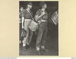 CAIRNS, QLD. 1944-10-30. LT C.T. HALMARICK, ARMY PHOTOGRAPHER, MILITARY HISTORY SECTION (1), WITH CAPT T.V. WALPOLE, AUSTRALIAN ARMY MEDICAL CORPS HQ 6 DIVISION (3), AWAITING EMBARKATION TO NEW ..