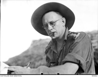 BABIANG, NEW GUINEA. 1944-11-09. CHAPLAIN W.N. ROOK, 2/6 CAVALRY (COMMANDO) REGIMENT, CENSORING MAIL BEFORE GOING ON A PATROL