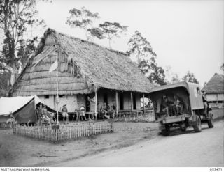 Sogeri, New Guinea. 1943-06-25. The main ward of the 11th Australian Field Ambulance with the flagpole in "Snifter Park" and the orderly room tent on the left