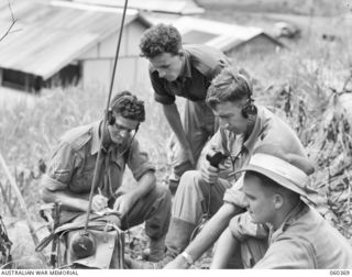 SOGERI, NEW GUINEA. 1943-11-20. STUDENTS OF THE SCHOOL OF SIGNALS, NEW GUINEA FORCE, WORKING WITH A 108 ARMY WIRELESS SET AT THE SCHOOL. SHOWN IS: NX20186 CORPORAL R. L. SAUNDERS (EXTREME LEFT)