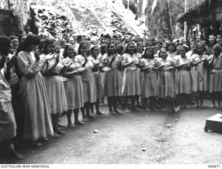 Ramale Valley, New Britain. Internees at the Ramale Valley internment camp applauding Major General K W Eather, General Officer Commanding 11 Division, at the conclusion of his address. contact ..