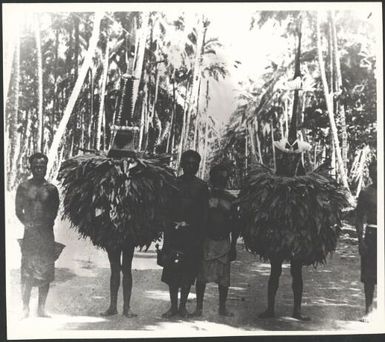 Two Dukduks with onlookers, Matupit, Rabaul Harbour, New Guinea, 1929 / Sarah Chinnery